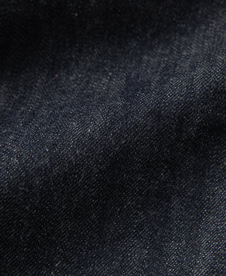 Indigo selvedge denim fabric close-up with visible textured weave