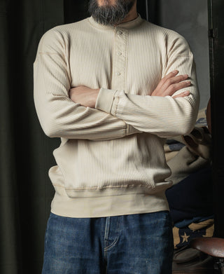 Apricot ribbed henley long-sleeve shirt, button placket and sleeves, front view
