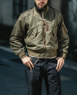 Olive flight jacket with chest pockets, front zipper, and arm patch