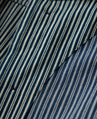 Striped cossack jacket fabric close-up with dark and light blue pinstripes