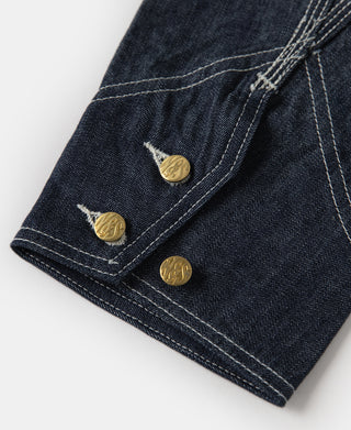 Indigo denim jacket cuff with three gold snap buttons and stitched placket
