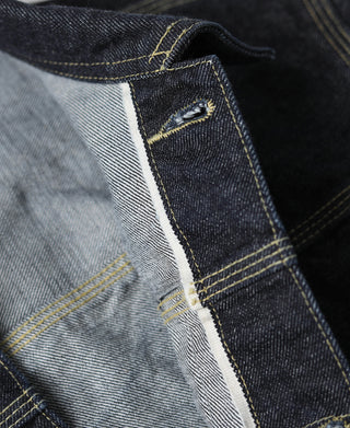 Indigo denim jacket placket edge with light lining and yellow stitching detail