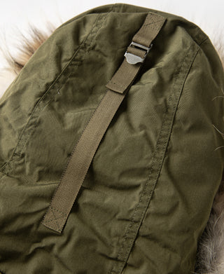 Olive parka hood edge with fur trim and adjustable strap at neckline
