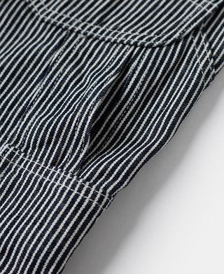 Striped carpenter pants side seam and pocket opening with clean contrast stitching