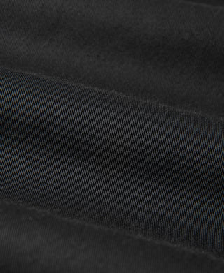 Black all-weather trench coat, close-up of textured woven fabric