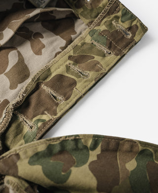 Camouflage cotton pants, waistband and upper leg with belt loops and buttoned fly panel.
