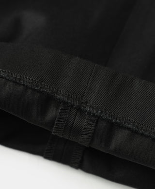 Black trouser hem with bartack stitching at the leg opening