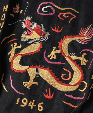 Black souvenir tour jacket with colorful embroidered dragon and “1946” detail