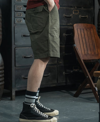 Olive fatigue utility shorts side view with buttoned cargo pocket