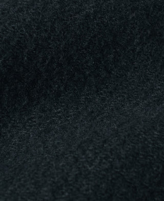 Pique salt-and-pepper stripe pants fabric close-up, dark textured surface