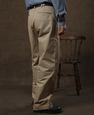 Tan chino trousers worn on model, front view with side seam