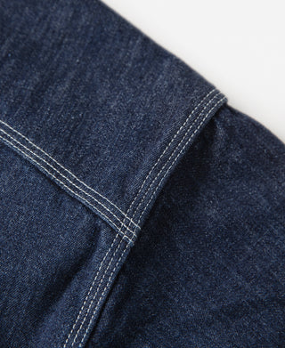 Denim workshirt sleeve placket seam with contrast topstitching, dark blue wash