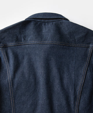 Indigo denim jacket back view with central seam and contrast tan topstitching