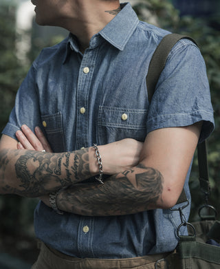 Blue chambray work shirt close-up, short sleeves, button placket, chest pocket