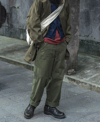 Olive utility fatigue pants with multiple pockets and buttoned waist