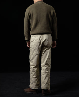 Olive crewneck wool sweater on model, back view with ribbed hem and cuffs.