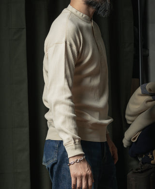 Apricot ribbed henley long-sleeve shirt, side view with relaxed fit