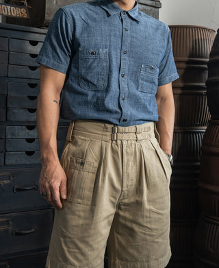 Blue short-sleeve button-up work shirt with two chest pockets and black buttons.