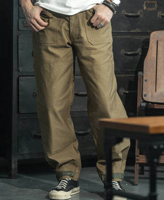 Khaki deck pants worn with large side cargo pockets and cuff buttons