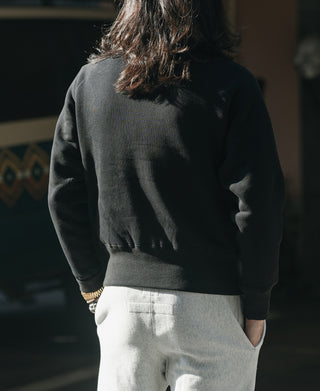 Black raglan crewneck sweatshirt back view, solid with no visible graphic