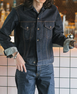 Indigo denim jacket with two flap chest pockets, button closure, and cuffed sleeves