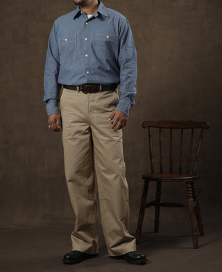 Tan chino trousers on model, full front view with waistband buttons