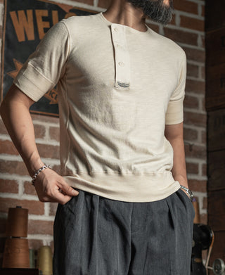 Cream henley T-shirt with short sleeves and button placket, front drape