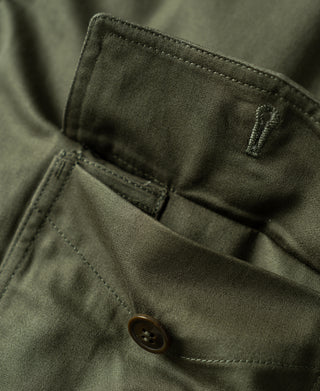 Olive flight jacket interior pocket with button and stitched divider seam