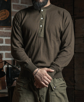 Man wearing olive-brown ribbed long-sleeve henley shirt with three-button placket