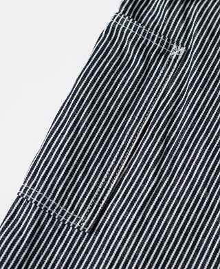Striped carpenter pants leg with stitched pocket panel and reinforced corner