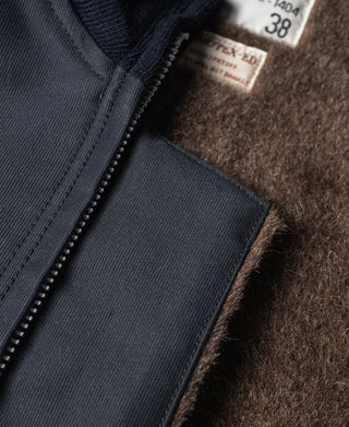 Navy deck jacket interior pocket panel beside zipper track close-up