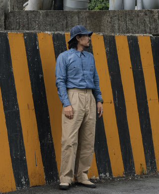Khaki combat pants worn with a blue shirt, straight legs and cuffed hem