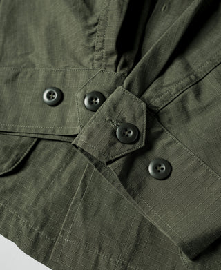 Olive fatigue jacket front with black button closures and utility flap