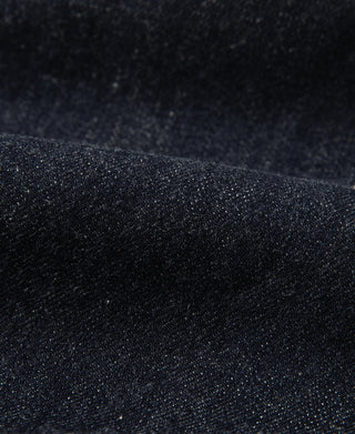 Indigo denim fabric close-up showing fine texture and diagonal twill weave
