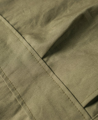 Olive field jacket close-up of stitched panels and seam construction