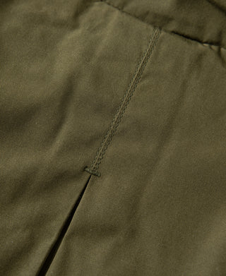Olive parka side seam and pleated panel with subtle stitching