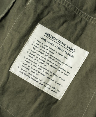 Olive jacket care instruction label with numbered steps