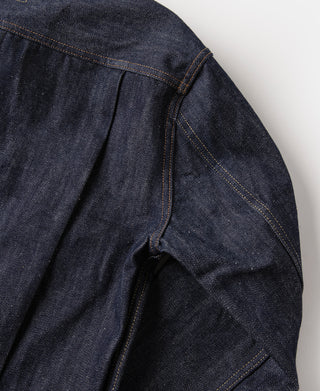 Indigo denim jacket side seam and curved vent with stitched pocket opening