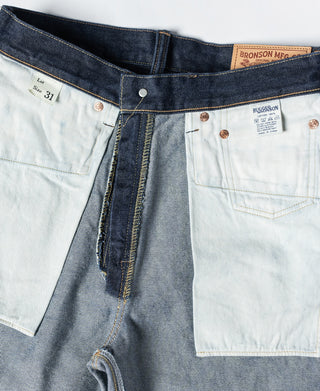 Indigo denim jeans waistband with button fly, belt loops, and light inner panel