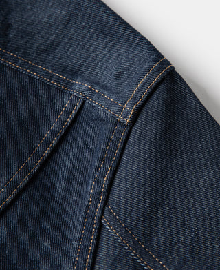 Indigo denim jacket shoulder/arm seam with contrast tan stitching lines