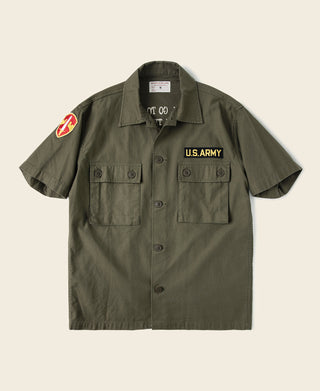 Olive vintage U.S. Army short-sleeve counselor shirt with button front and chest flap pockets