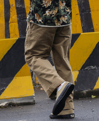 Khaki cargo trousers worn with cuffs and ankle-length hem