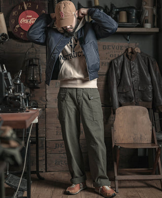 Navy flight jacket worn by model, zip front with ribbed cuffs and knit collar