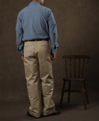 Tan chino trousers on model, back view with centered yoke seam