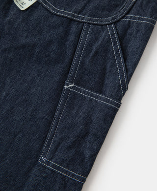Indigo denim painter pants, front pocket and waistband seam close-up