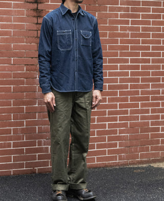 Denim workshirt on model with button-front and chest flap pockets, dark blue