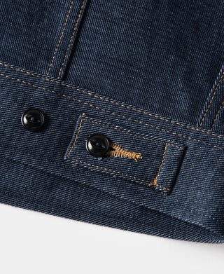 Indigo denim jacket button placket detail with gold-tone bar accents