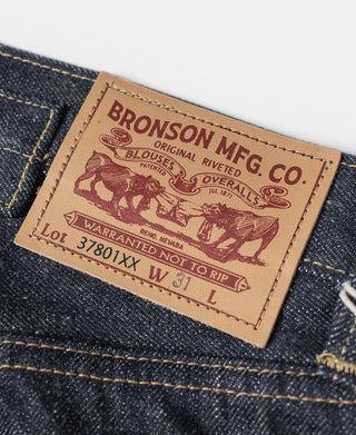 Indigo denim jeans leather brand patch with Bronson Mfg Co label and lot number