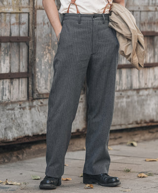 Dark striped pants on a model, straight legs with belt loops