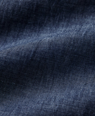 Indigo chambray fabric weave texture with visible seam stitching